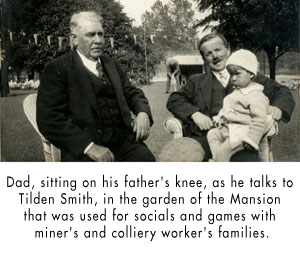 Dad, sitting on his father's knee, as he talks to Tilden Smith, in the garden of the Mansion that was used for socials and games with miner's and colliery worker's families.